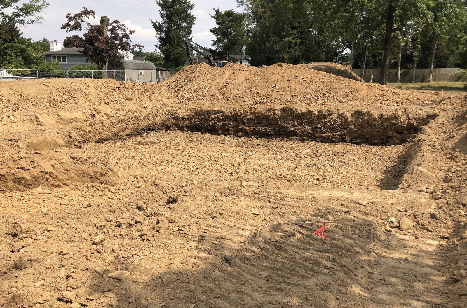Freshly dug basement hole, squared up and ready for footings