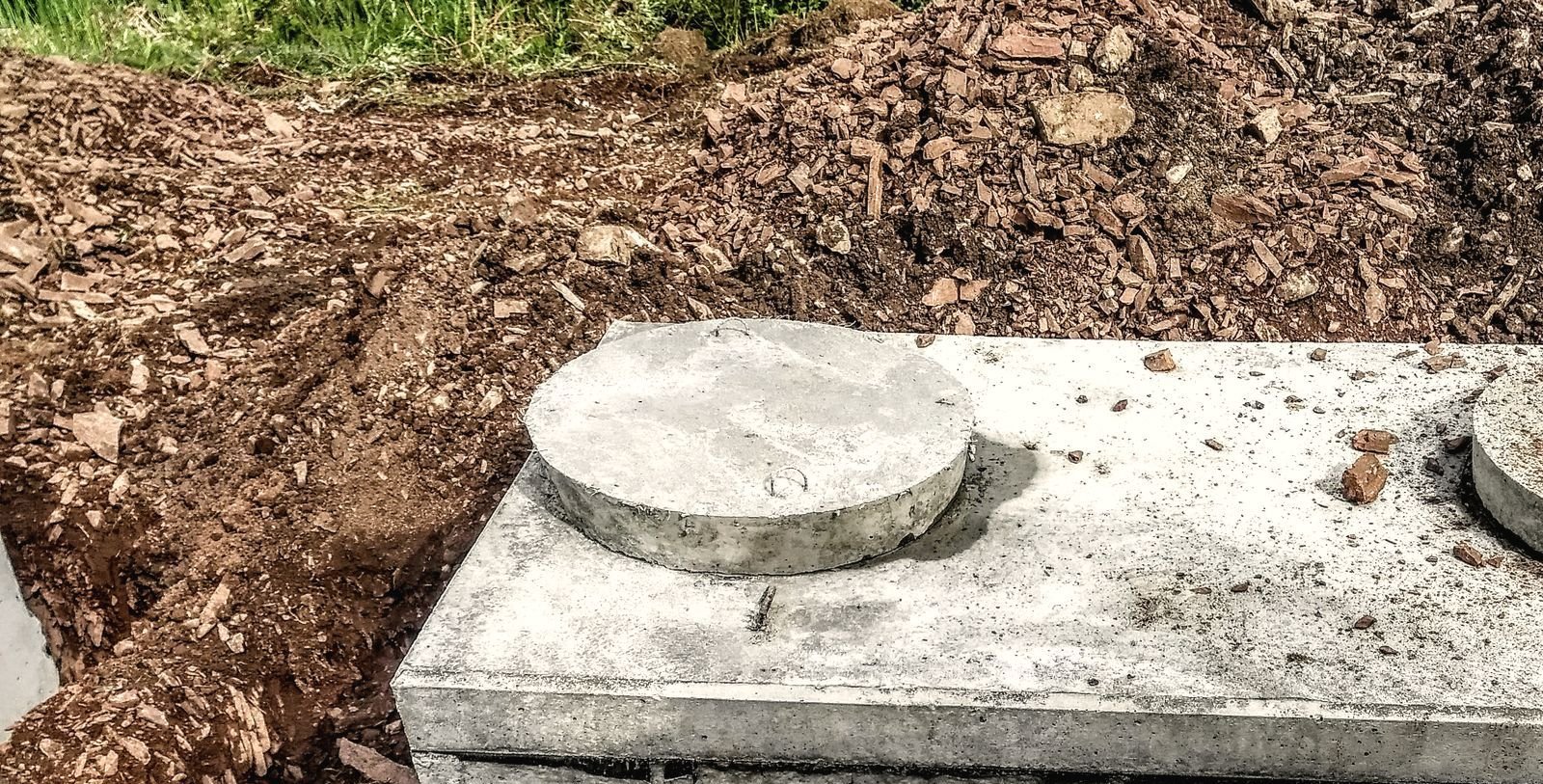 Septic tank being set into an excavation